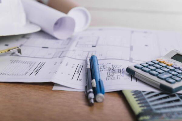 close-up-pens-calculator-plans-scaled-qwthivnfb77igmlm1obbf0o2zfzyyn9uh1lv4c2v1c