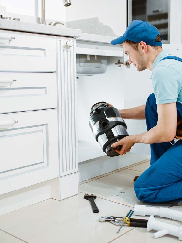 male-plumber-in-uniform-installing-disposer-resize