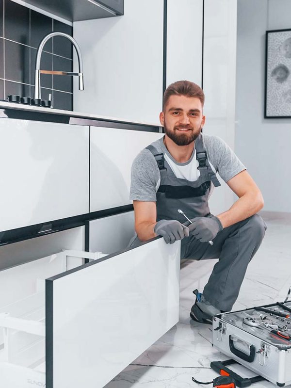 young-professional-plumber-in-grey-uniform-using-e-resize.jpg